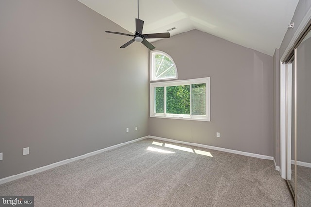 unfurnished bedroom with ceiling fan, carpet floors, and vaulted ceiling