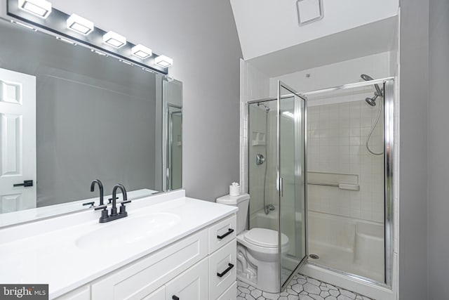 bathroom with tile patterned floors, vanity, toilet, and walk in shower