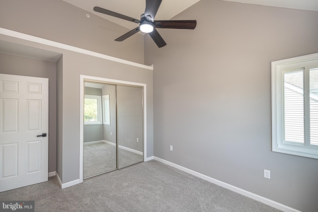 unfurnished bedroom with ceiling fan, a closet, and light carpet