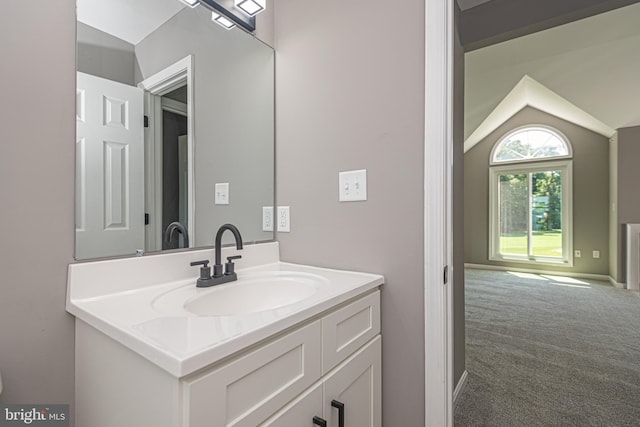 bathroom with vanity and vaulted ceiling