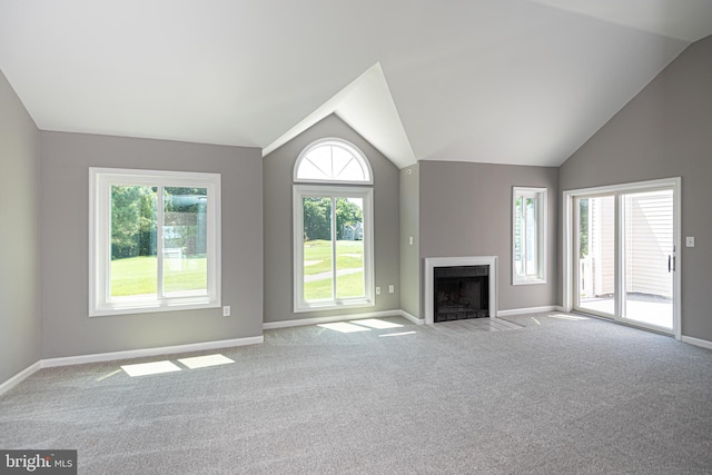 unfurnished living room featuring light carpet and vaulted ceiling