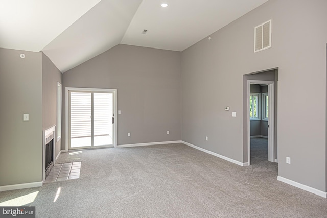 unfurnished living room with light colored carpet and lofted ceiling