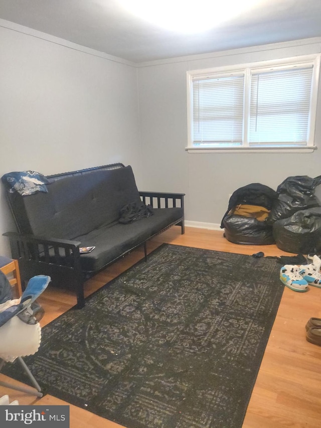 sitting room featuring hardwood / wood-style flooring and ornamental molding