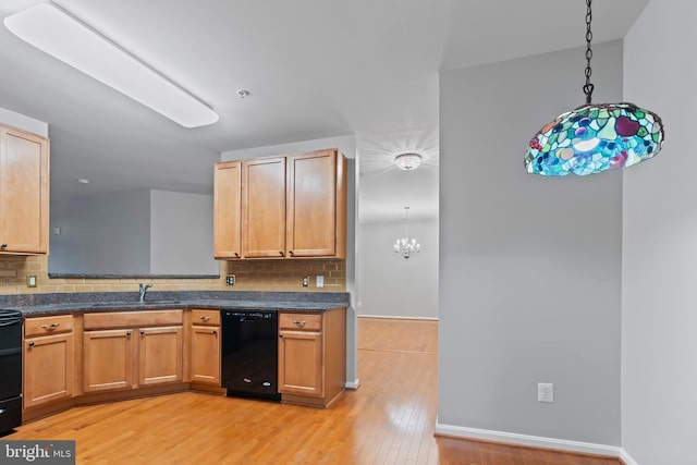 kitchen with decorative backsplash, pendant lighting, light hardwood / wood-style floors, and black appliances