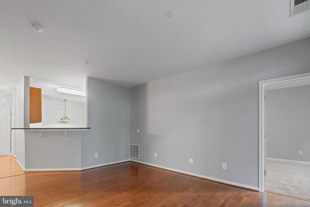 unfurnished living room with hardwood / wood-style flooring