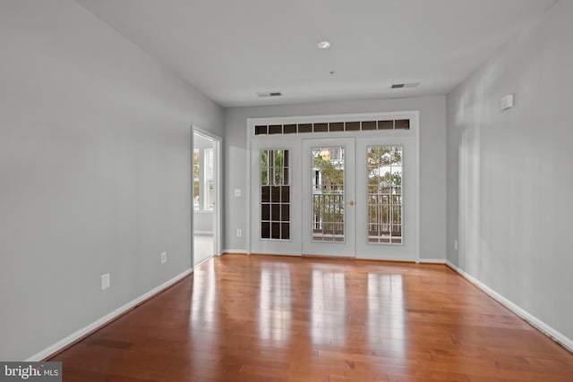 unfurnished room with light wood-type flooring