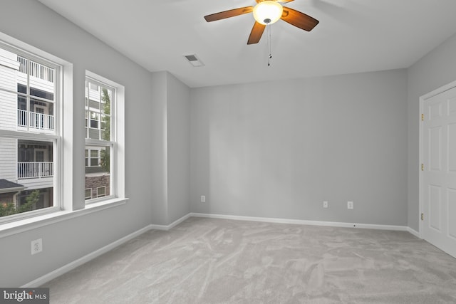 unfurnished room featuring light colored carpet and ceiling fan