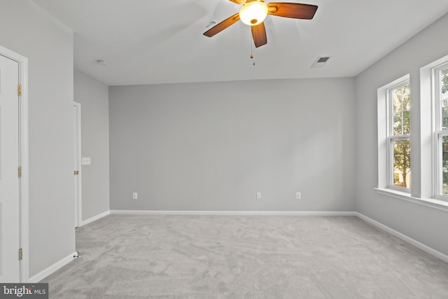 unfurnished room featuring ceiling fan and light colored carpet