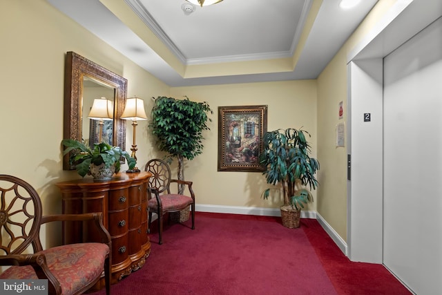 living area featuring carpet floors, a tray ceiling, elevator, and ornamental molding