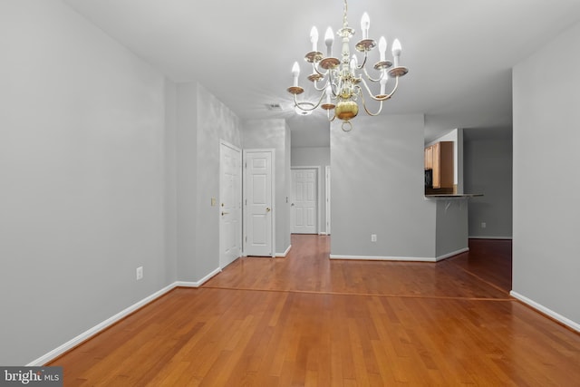 interior space featuring hardwood / wood-style floors and a chandelier