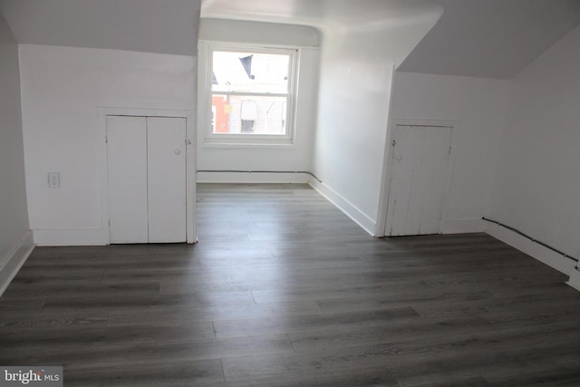 bonus room with dark wood-type flooring