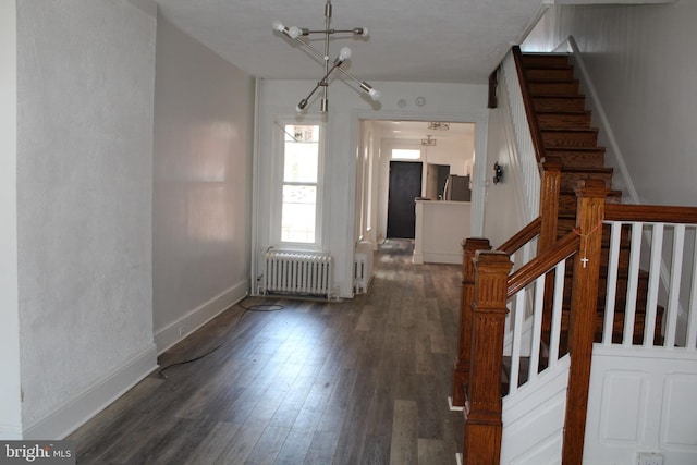 interior space with radiator, a chandelier, and hardwood / wood-style flooring