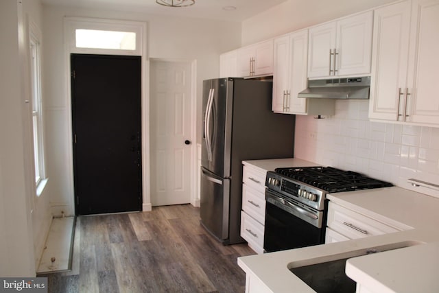 kitchen with white cabinets, backsplash, stainless steel appliances, and dark hardwood / wood-style floors