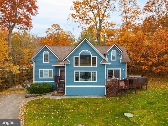 view of front of house featuring a front yard and a deck