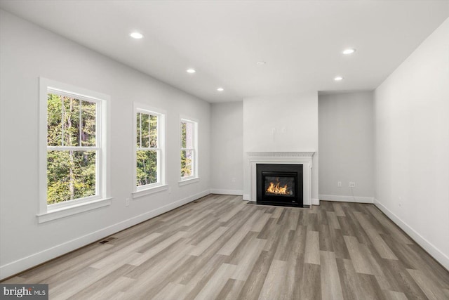 unfurnished living room with light wood-type flooring