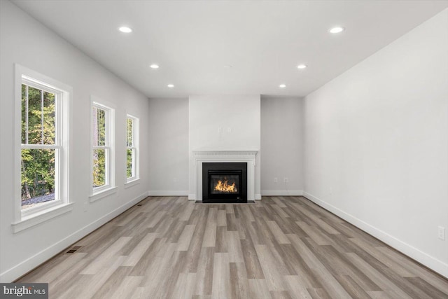 unfurnished living room with light hardwood / wood-style flooring