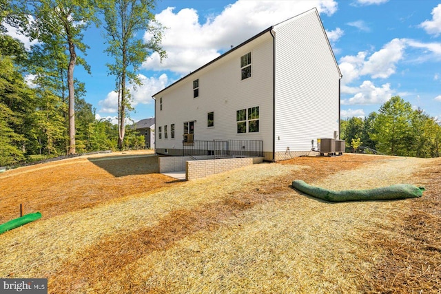 view of side of home featuring central AC