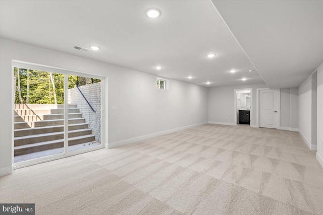 basement featuring light colored carpet