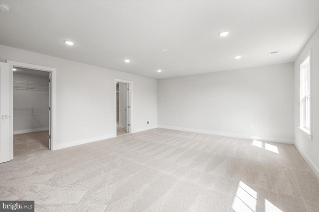 unfurnished room featuring light carpet