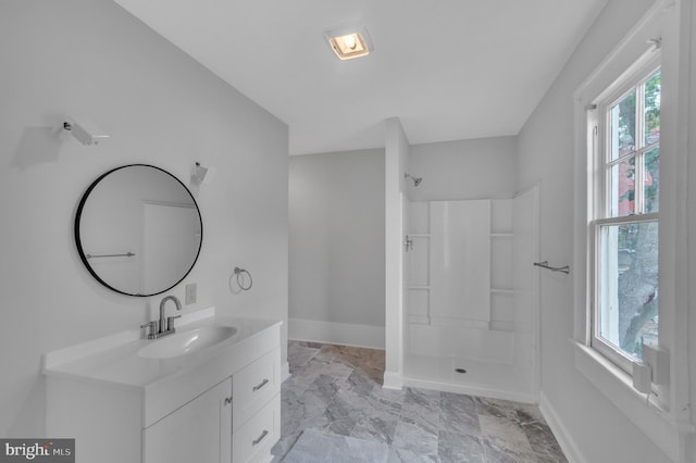 bathroom with a shower, vanity, and tile patterned flooring