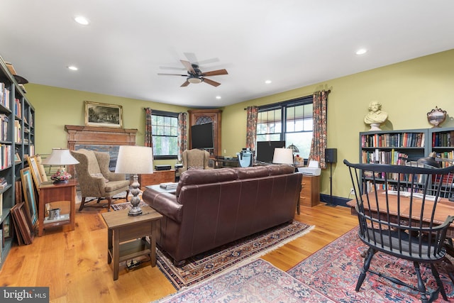 living room featuring plenty of natural light, ceiling fan, and light hardwood / wood-style floors