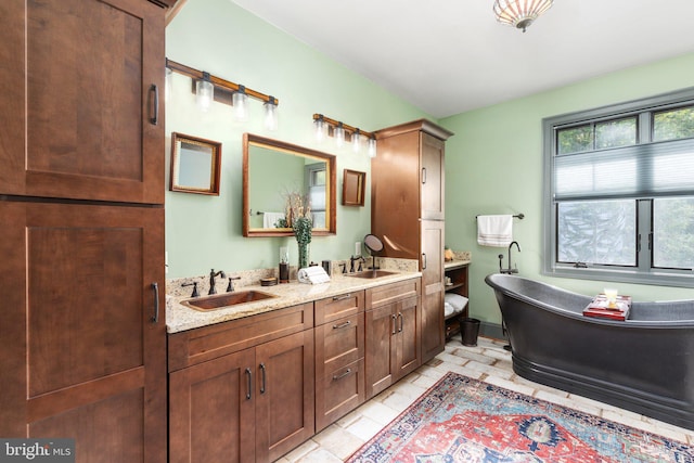 bathroom featuring tile patterned flooring, dual bowl vanity, and a bathtub