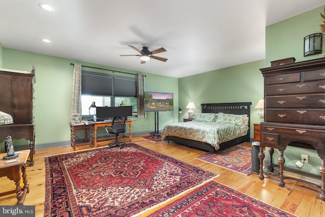 bedroom with light hardwood / wood-style flooring and ceiling fan