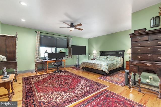 bedroom with ceiling fan and light hardwood / wood-style flooring