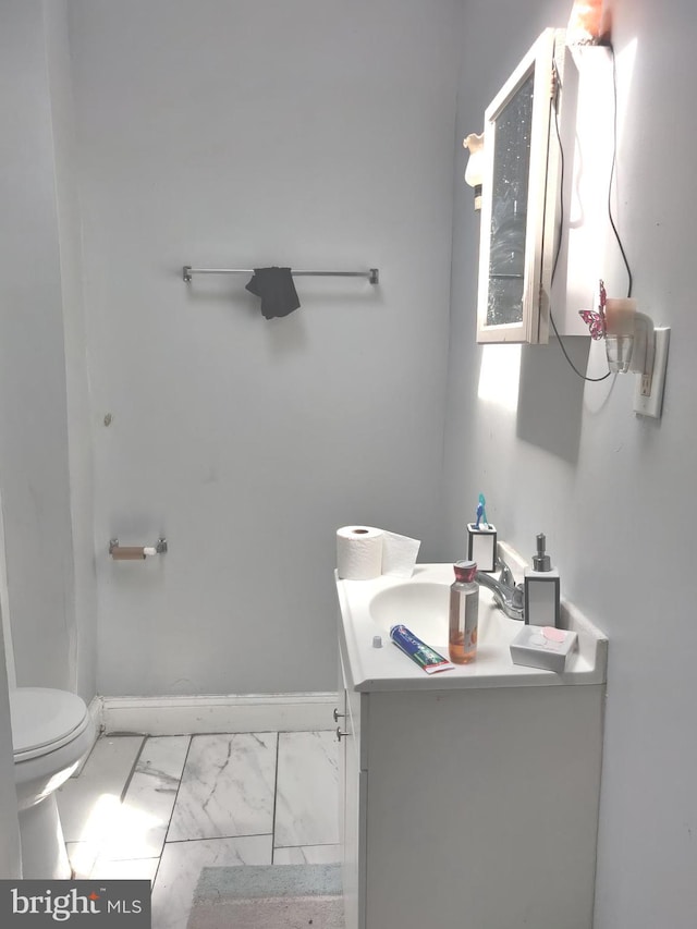 bathroom featuring vanity and toilet