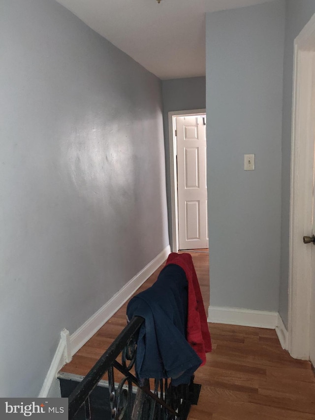 hallway with dark hardwood / wood-style floors