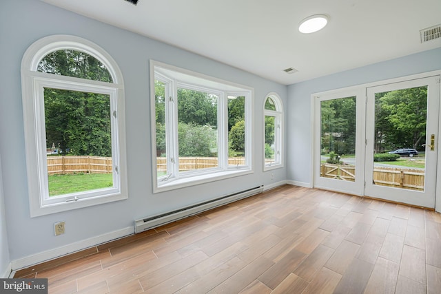 unfurnished sunroom featuring baseboard heating