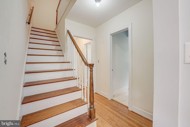 stairs with hardwood / wood-style flooring