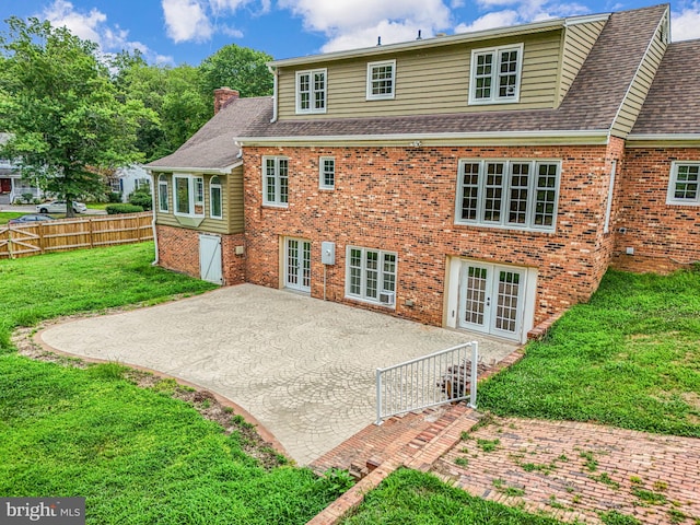 back of house with french doors, a yard, and a patio