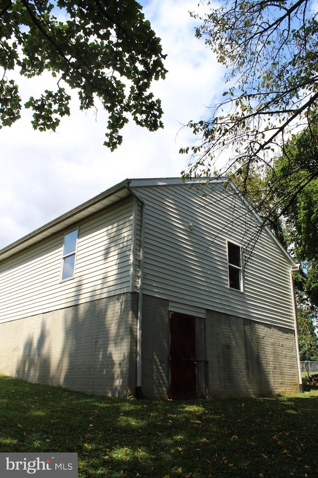 view of side of home with a lawn