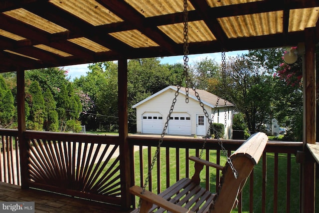 wooden deck with an outdoor structure, a lawn, and a garage