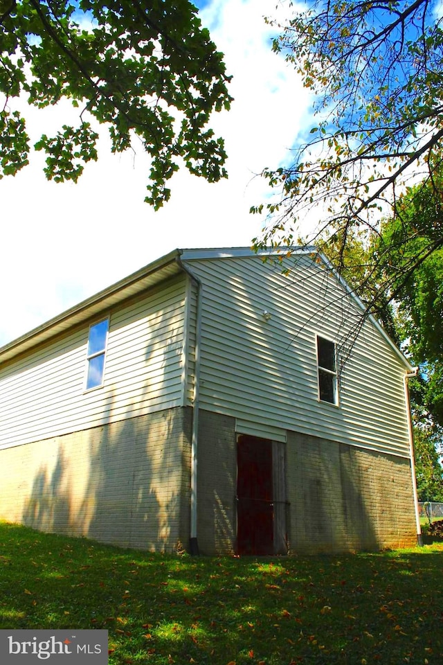 view of property exterior featuring a lawn