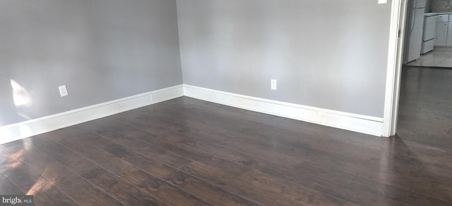 empty room featuring dark wood-type flooring