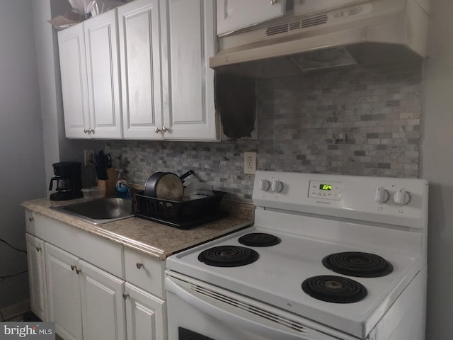 kitchen with white cabinets, backsplash, white electric range oven, and sink