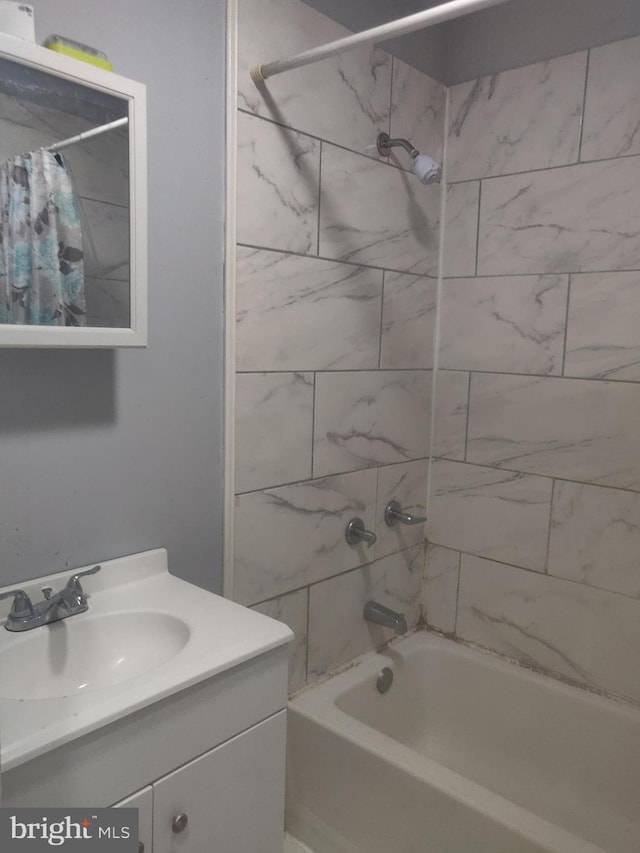 bathroom featuring vanity and shower / bath combo with shower curtain