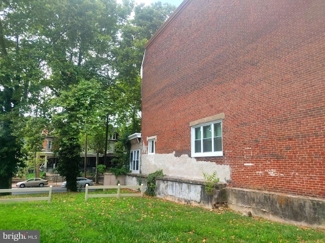 view of side of home featuring a yard