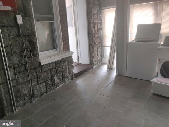 clothes washing area with washer and dryer and tile patterned flooring