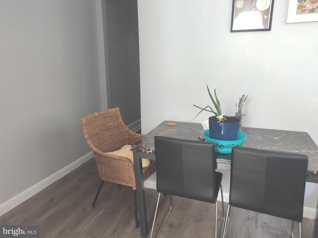 dining space with dark wood-type flooring