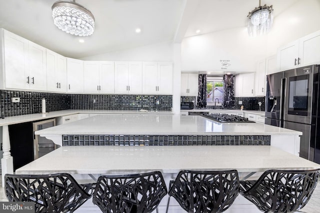 kitchen featuring white cabinets, a chandelier, and a center island