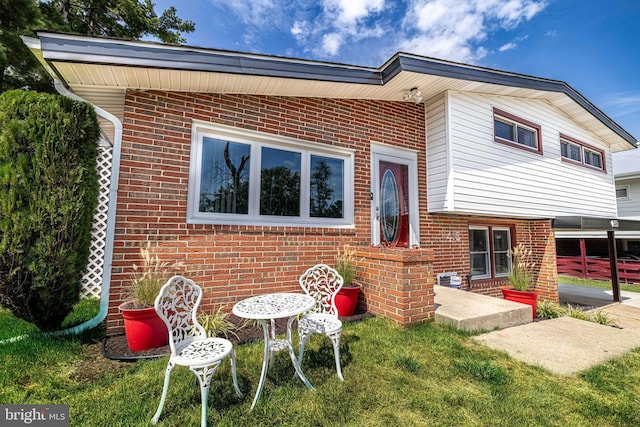 rear view of house featuring a yard