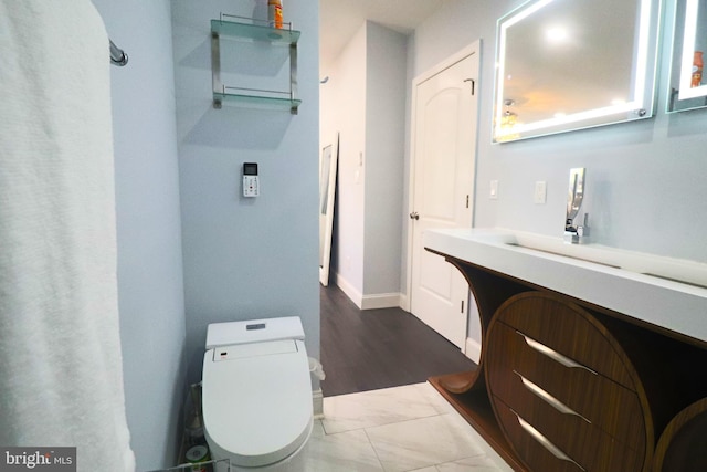 bathroom with toilet and vanity