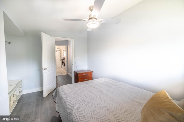 bedroom with ceiling fan, dark hardwood / wood-style flooring, and lofted ceiling