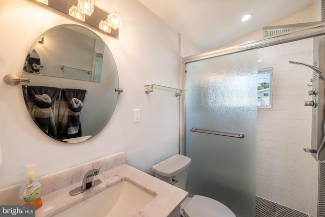 bathroom featuring toilet, vaulted ceiling, an enclosed shower, and vanity