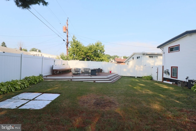 view of yard featuring a deck and a jacuzzi