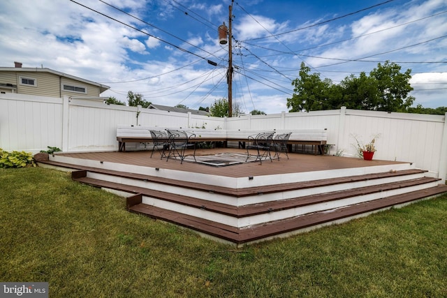 wooden terrace featuring a lawn