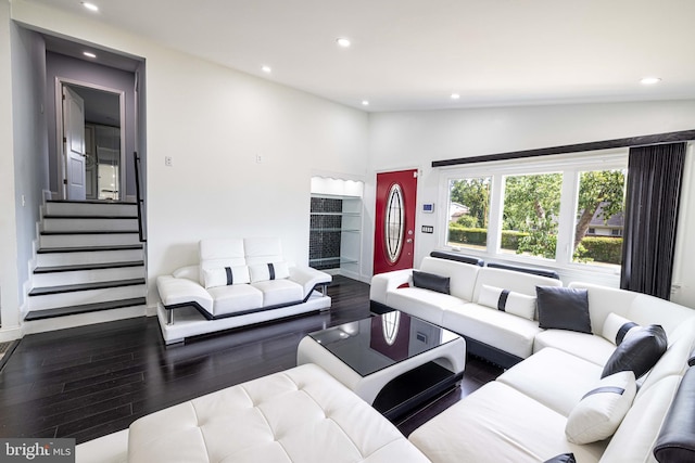 living room featuring lofted ceiling and hardwood / wood-style flooring